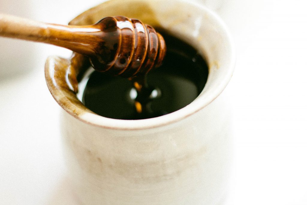honey dripping from honey dipper
