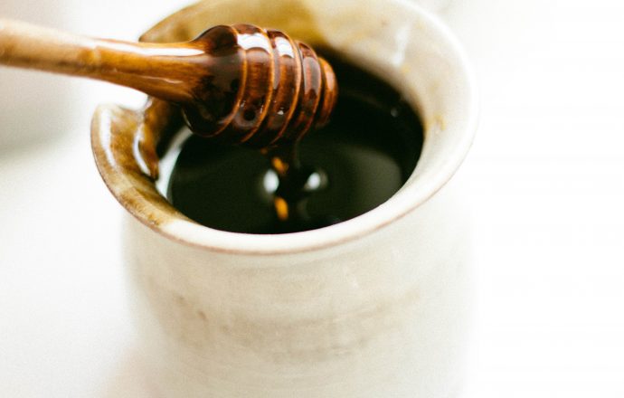 honey dripping from honey dipper