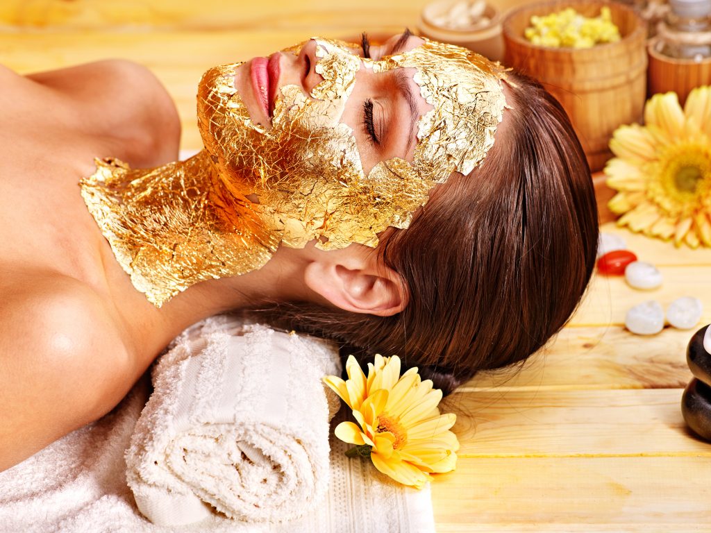 Woman Getting Gold Facial Mask